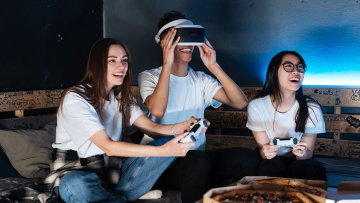 Group of Young Gamers Playing with a VR Headset