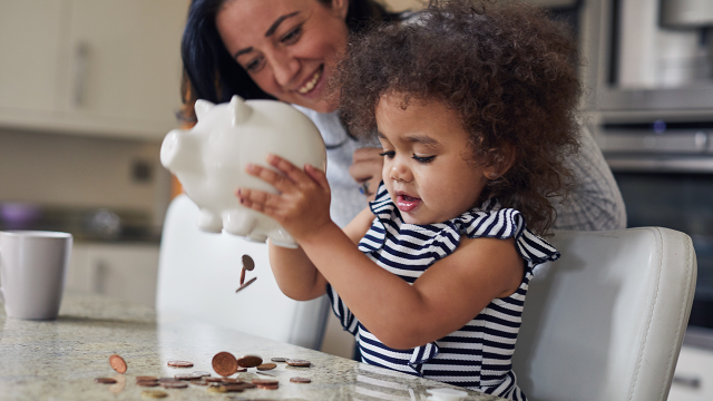 mom and daughter with piggy bank